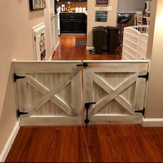 an open door leading to a kitchen and living room with wood floors in the background