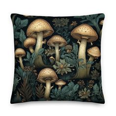 a black pillow with mushrooms and plants on it