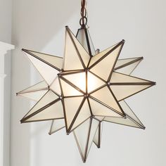 a moravian star light hanging from the ceiling