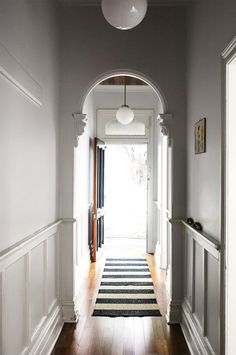 the hallway is clean and ready to be used as an entrance way for someone's home