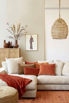 a living room filled with lots of furniture and decor on top of a hard wood floor