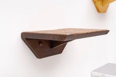 a wooden shelf mounted to the side of a wall