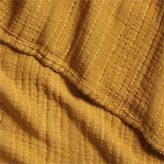 the texture of an old yellow blanket