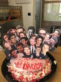 a cake that has been decorated with photos of people on it and the words aon spelled out