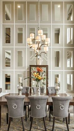 a dining room table with chairs and a chandelier