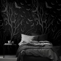 black and white photo of a bedroom with bats on the wall, bedding and pillows