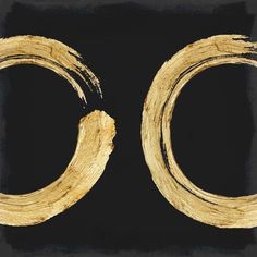 two gold rings on a black background