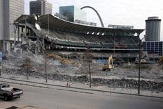 the stadium is being demolished by construction workers