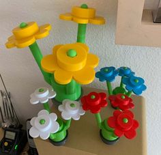 some plastic flowers are sitting on a table