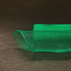 a roll of green mesh sitting on top of a table