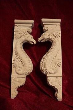 two white decorative brackets on a red velvet background