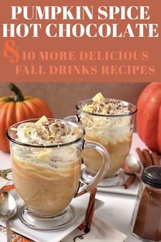 two mugs filled with coffee and topped with whipped cream, nuts and pumpkins