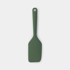 a green spatula on a white background