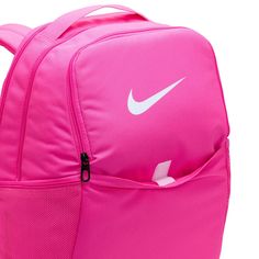 Grab your gear and get going with the Nike Brasilia Backpack. It has plenty of pockets to help you stay organized, including a sleeve to fit your laptop, side mesh pockets for water bottles, and a zippered pocket on the inside to keep small items secure. This product is made with at least 50% recycled polyester fibers. Haul loop at the top. Spacious main compartment. Padded, adjustable shoulder straps. Front zip pocket. Internal laptop sleeve. Dimensions: 18" H x 12" W x 7" D. Capacity: 24 L. Sh Pink Functional Outdoor Backpack, Functional Pink Outdoor Backpack, Sporty Pink Backpack For School, Pink Bags For Outdoor And Back To School, Sporty Pink School Backpack, Pink Nylon Backpack For Daily Use, Pink Nylon Outdoor Backpack, Pink Standard Backpack For Outdoor, Pink Backpack For Outdoor