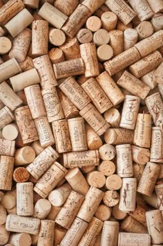 many different types of wine corks stacked on top of each other in a pile