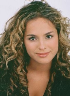 a close up of a person with curly hair