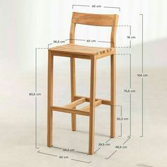 a wooden bar stool with measurements for the seat and backrests to fit in