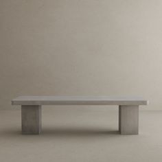 a concrete bench sitting on top of a white floor