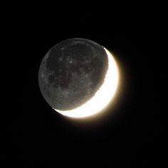 the moon is seen in the dark sky