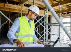 a construction worker working on his laptop computer