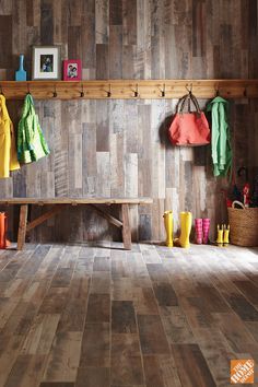 a room with wood flooring and colorful items hanging on the wall next to it