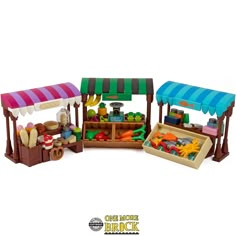 an assortment of toys including fruits and vegetables on display in a wooden stand with awnings