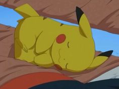 the pikachu is laying down on the bed