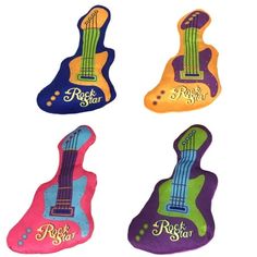 four colorful guitar shaped magnets with the words rock star on them