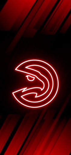 the atlanta hawks logo is lit up in red and black with white lines on it