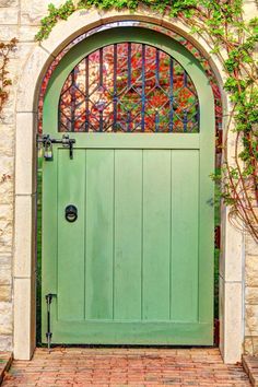 a green door with an arched glass window