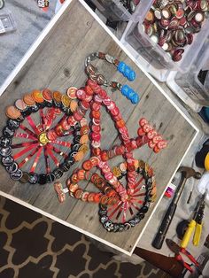 an assortment of buttons and other crafting supplies on a wooden table in a room