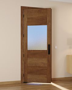 an empty room with a wooden door and light wood flooring is seen in this image