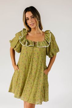 the answer to your puff sleeve prayers, this vintage-inspired green floral mini dress will take you from day to night, season after season. it features a dainty ruffle neckline, dramatic puff sleeves, + a muted multi-color floral pattern. with its relaxed silhouette + flowy shape, it’s the perfect puff sleeve mini dress to pair with your favorite heels, boots, sandals, or sneaks. green base + cream stitch // scoop neckline, front tie, dramatic puff sleeves, pockets, lined model is 5'8" + wearing