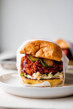 a sloppy joe sandwich on a white plate