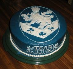 a blue and white cake sitting on top of a wooden table