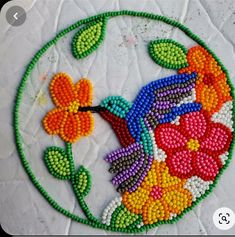 a colorful beaded bird with flowers on it