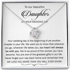 a white box with a necklace in it that says, to our beautiful daughter on your wedding day