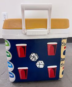 a cooler that has some drinks and dices on it