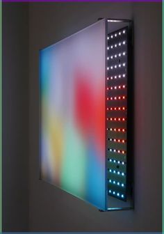 a colorful light box mounted on the wall