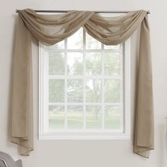 an open window with sheer curtains hanging from the side