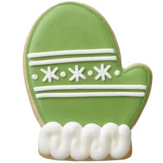 a green cookie with white frosting on it's face and the shape of a mitt