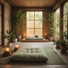 a room that has some plants and candles on the floor in front of it,