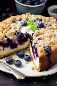 a blueberry crumb cake on a white plate with a slice missing from it