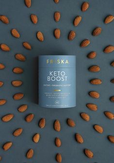 a can of friskka keto booster surrounded by almonds on a grey background