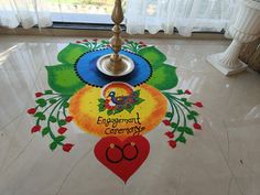 the floor is decorated with colorful designs on it and has a light that says, engagement ceremony