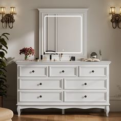 a white dresser and mirror in a room