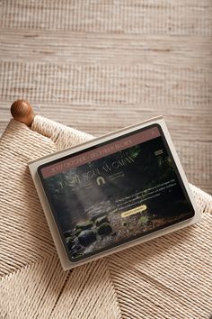 a wooden mallet sitting on top of a bed next to a pillow and blanket