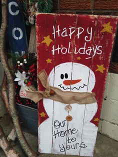 a wooden sign that says happy holidays with a snowman on it and the words, our home is yours