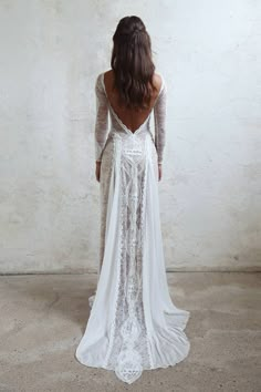 the back of a woman's wedding dress, with long sleeves and open shoulders