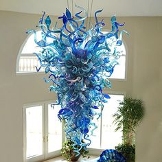 a large blue glass chandelier hanging from the ceiling